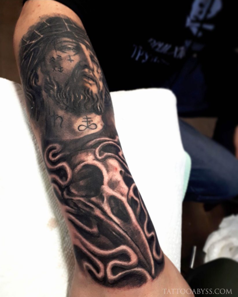 Black and grey Jesus Christ half sleeve tattoo.