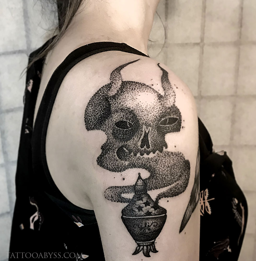 Traditional style genie lamp tattoo located on the