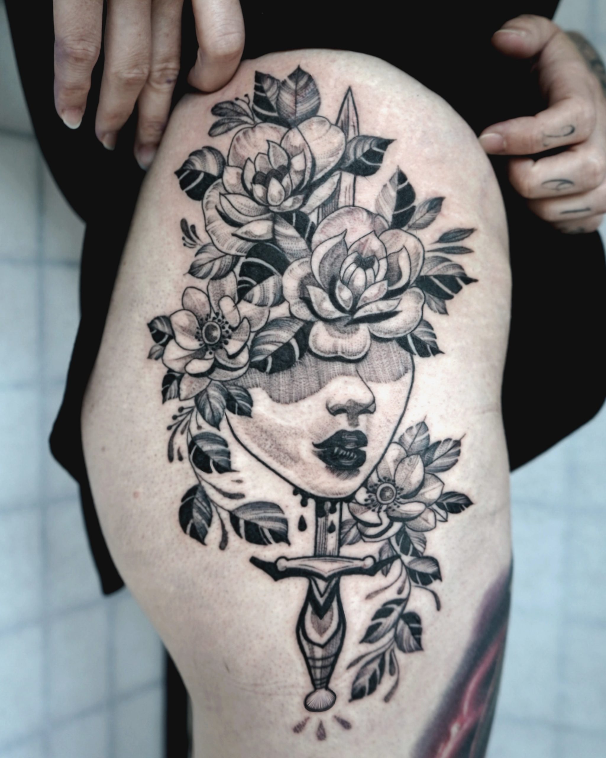 Woman-dagger-flowers-tattoo-abyss