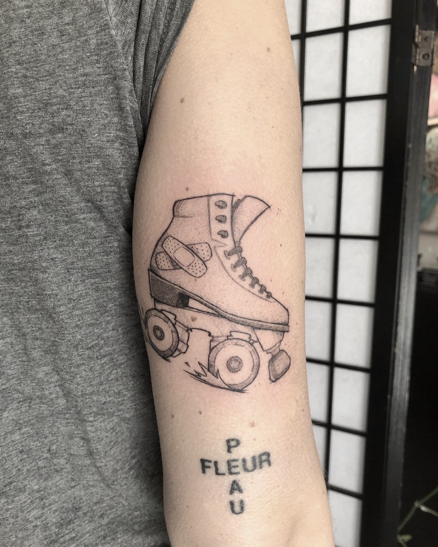 Fine line style roller skater tattoo on the back