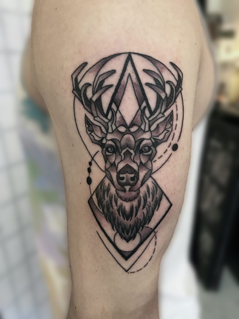Little forearm tattoo of a reindeer on Rosa.